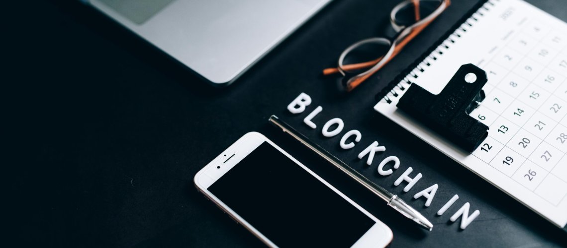 Free Flat lay of a modern digital workspace with blockchain theme, featuring a smartphone and calendar. Stock Photo, Blockchain Technology